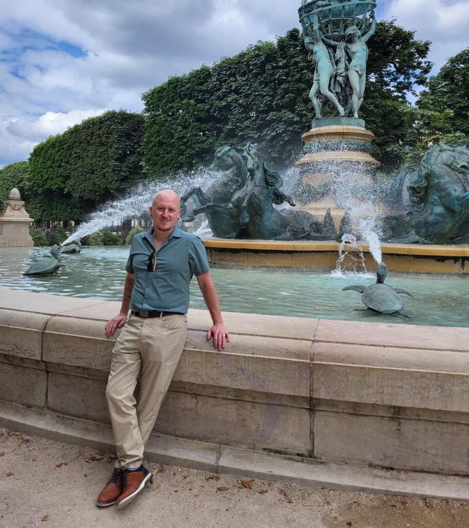 Evan Barr, RMT, leaning against a fountain